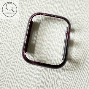 May include: A rectangular smartwatch protective case featuring a dark purple and black marbled pattern with a glossy finish. The frame has rounded corners and a side cutout for buttons, displaying the GOBANDZUS logo in the upper left corner.