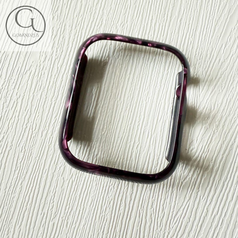 May include: A rectangular smartwatch protective case featuring a dark purple and black marbled pattern with a glossy finish. The frame has rounded corners and a side cutout for buttons, displaying the GOBANDZUS logo in the upper left corner.