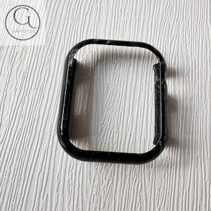 May include: Black phone case with a marbled pattern.