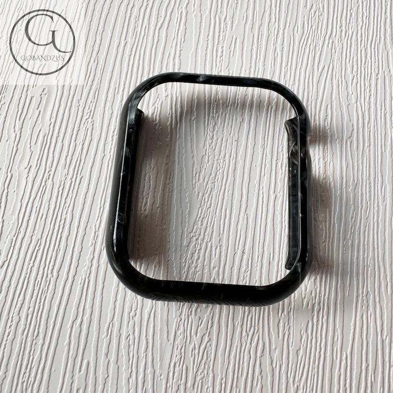 May include: Black phone case with a marbled pattern.