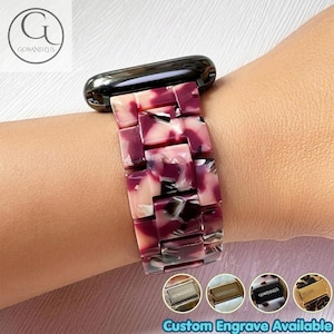 May include: A watch band featuring a link-style design with a marbled pattern in shades of burgundy, pink, and white. The band is constructed from rectangular resin links and includes a black metal connector piece at the top of the watch strap.