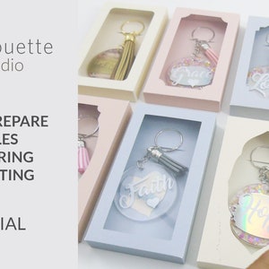 May include: A tutorial on how to prepare files for scoring and cutting using Silhouette Studio software. The image shows several keychains with different words and designs, including "Faith", "Love", "Hope", and "Grace".