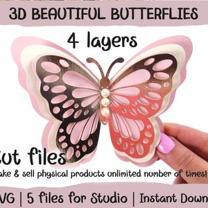 Puede incluir: Un dise&ntilde;o de mariposa en 3D de cuatro capas, cortado en papel rosa y blanco. La mariposa tiene un acabado dorado met&aacute;lico y un adorno de perla en el centro. La imagen incluye el texto "3D BEAUTIFUL BUTTERFLIES", "4 layers", "Cut files", "Make & sell physical products unlimited number of times!" y "5 SVG | 5 files for Studio | Instant Download".