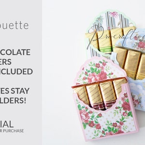 May include: Three different patterned paper boxes with a scalloped top, each holding a row of Merci chocolate bars. The boxes are in pink, blue, and green.