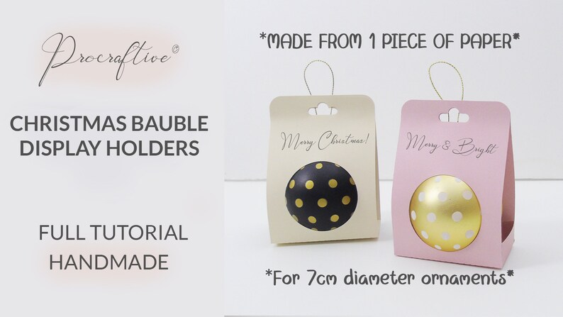 Op de afbeelding: Twee kerstbalhouders gemaakt van &eacute;&eacute;n stuk papier. De houders zijn beige en roze en hebben een uitsparing voor een kerstbal van 7 cm doorsnee. De beige houder heeft de tekst "Merry Christmas!" en de roze houder heeft de tekst "Merry & Bright".