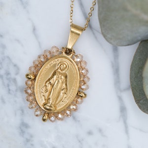 Our Lady necklace surrounded by golden pearls