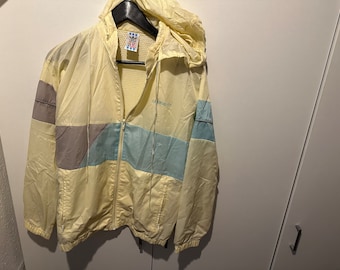 May include: A yellow, blue, and gray windbreaker jacket with a zipper closure and a hood. The jacket has the Adidas logo on the left chest.