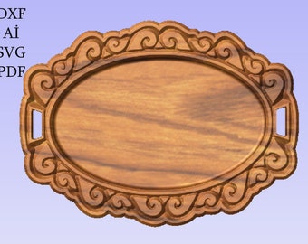 May include: A wooden serving tray with a decorative, ornate border and two handles. The tray is oval shaped and has a natural wood finish.