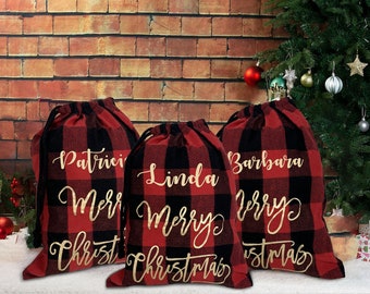 May include: A white ceramic mug with a black handle and the text "But First, Coffee" in a bold, black font. The mug is set against a blurred background, suggesting a cozy setting.