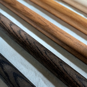 Displaying wood finishes from left to right: Black (bold dark), Dark Brown (deep brown), Brown (classic warm hue), Natural (light, subtle finish), and Unfinished (natural raw wood).