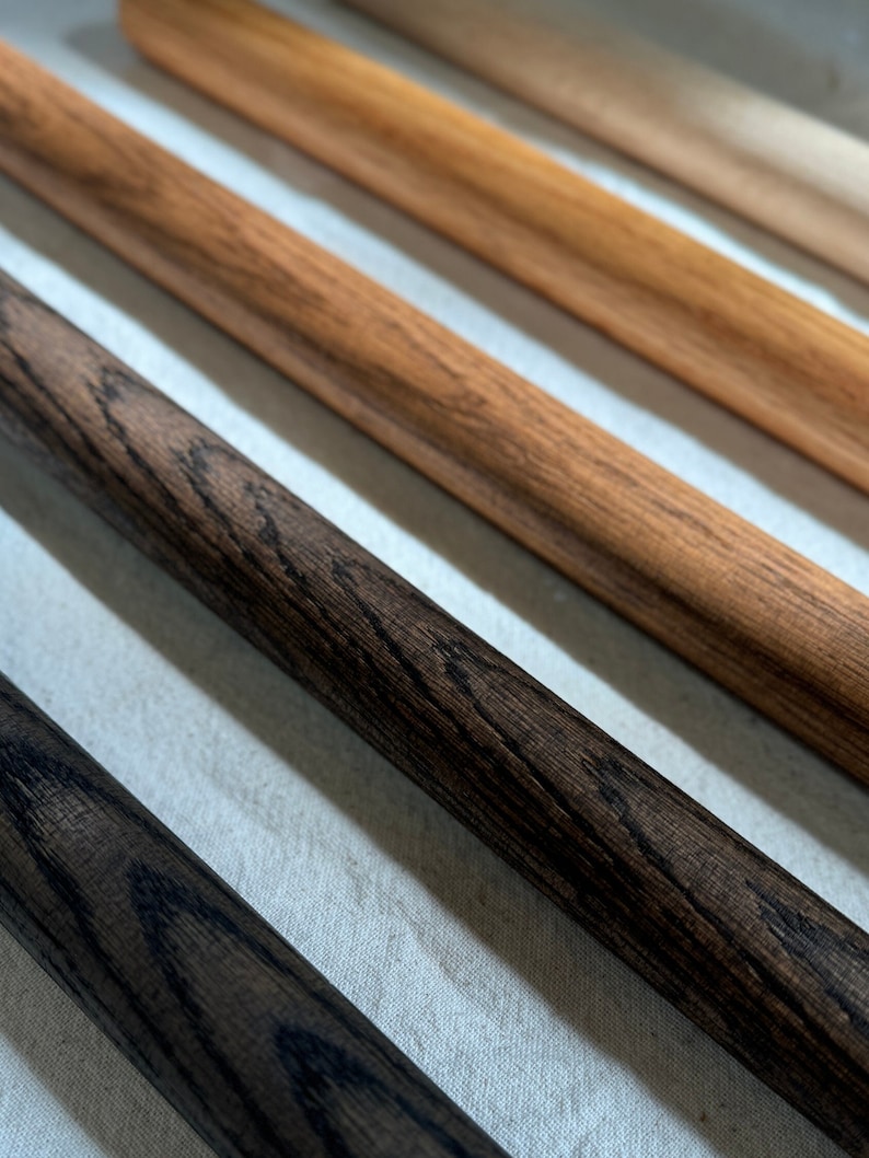 Displaying wood finishes from left to right: Black (bold dark), Dark Brown (deep brown), Brown (classic warm hue), Natural (light, subtle finish), and Unfinished (natural raw wood).