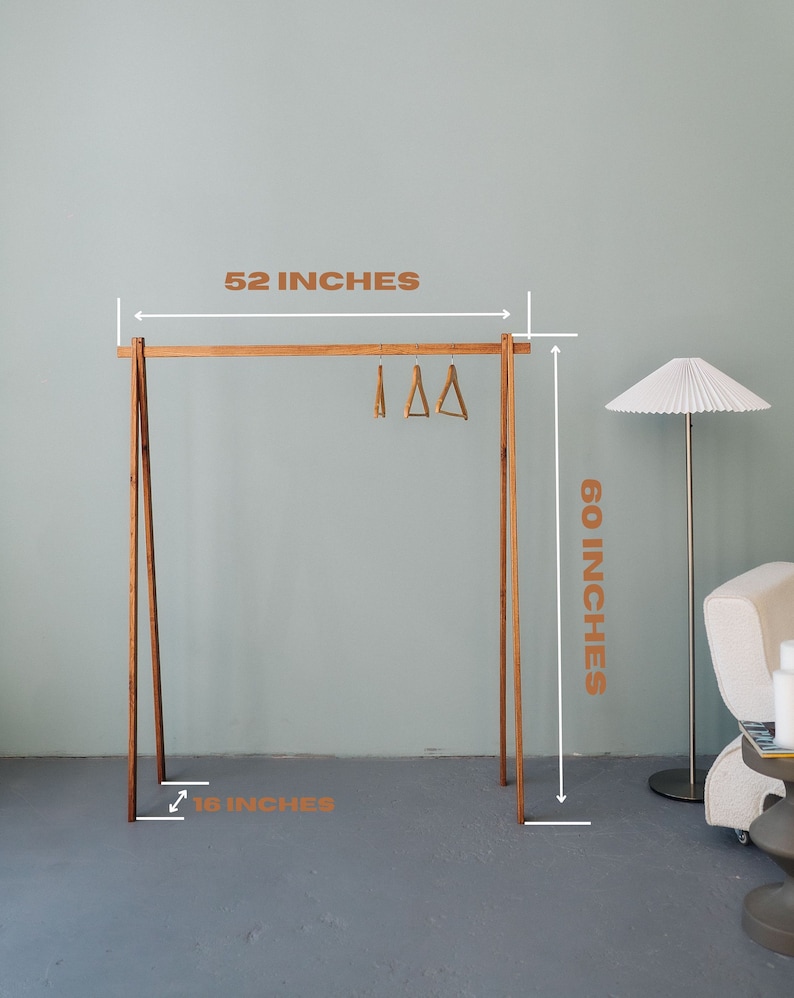 Ash wood clothing rack with a minimalist A-frame design. Dimensions: 52" W x 60" H x 16" D. Easy to assemble and move, perfect for bedrooms or boutiques. Its natural wood finish suits modern, rustic interiors for a stylish display solution.