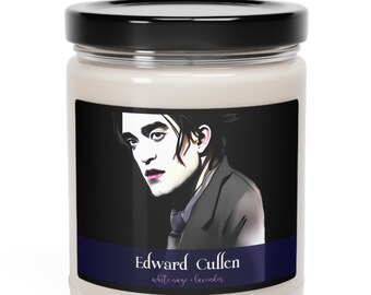 May include: A glass candle jar with a black lid and a label featuring a portrait of Edward Cullen from the Twilight saga. The label reads "Edward Cullen, white sage - lavender".