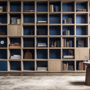 May include: A large wooden bookshelf with blue shelves and a variety of books, decorative items, and boxes. The bookshelf is in a room with a blue armchair and a wooden side table.