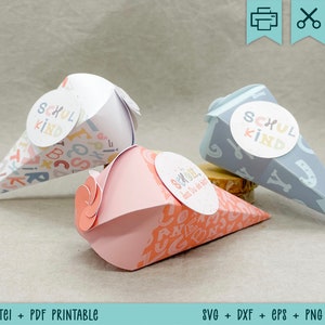 May include: Three decorative paper cones, each with a different pattern and the words "SCHUL KIND". The cones are in pink, white, and blue, and are decorated with letters and other shapes.