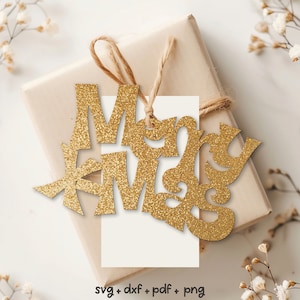 May include: Gold glitter "Merry Christmas" cutout on a brown gift bag with a white card and twine.