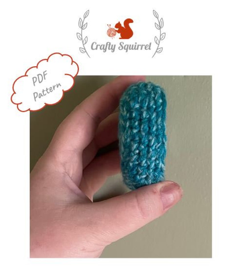 May include: A teal and white crocheted  coin purse or small pouch. The purse is held in a hand.