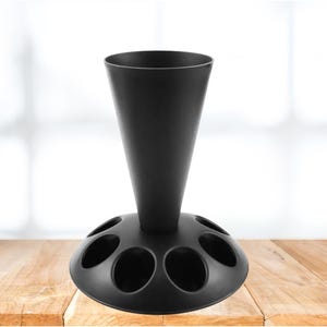 May include: A black plastic stand with a cone-shaped top and six circular openings in the base. The stand is designed to hold multiple items, such as wine glasses or bottles.
