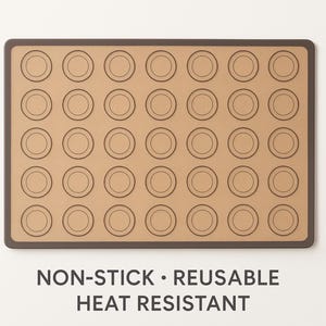 May include: A rectangular, brown non-stick baking mat with a dark brown border. The mat features 35 circular indentations for baking macarons. The text "NON-STICK • REUSABLE HEAT RESISTANT" is printed at the bottom of the mat.