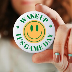 Wake Up It&#39;s Game Day Pin: Green & Gold Smiley Face Button