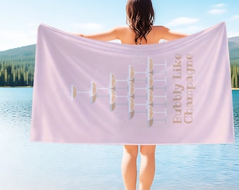 May include: Pink beach towel with a champagne glass design and the text "Bubbly Like Champagne".
