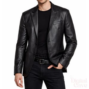 May include: A black leather blazer with a two-button closure, notched lapels, and a chest pocket. The jacket has long sleeves and a tailored fit. The model is wearing a black t-shirt and black jeans. The blazer is a classic style.