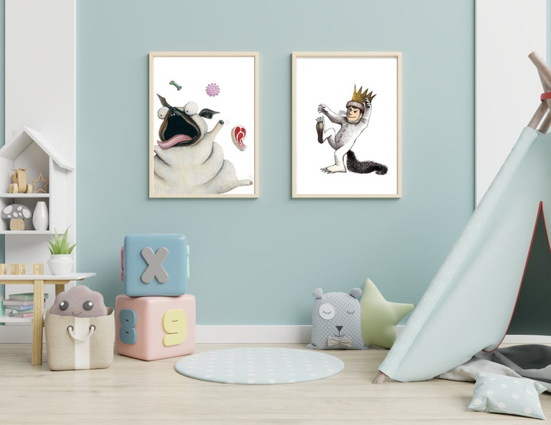 May include: Two framed illustrations on a light blue wall. The illustration on the left shows a cartoon pug with a surprised expression, surrounded by floating objects. The illustration on the right shows a cartoon creature wearing a crown, with one leg raised.