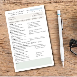 May include: A Real Estate Agent Session Notes form with checkboxes, a pen, a pair of glasses, and a cup of coffee on a wooden surface. The form includes sections for client information, meeting type, and buyer needs.