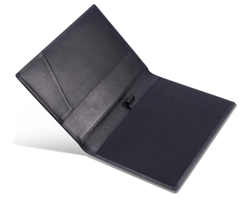 May include: Open black leather portfolio with a dark blue interior. The portfolio has a pocket on the left side and a pen holder. The cover is slightly angled, revealing the interior. The portfolio is designed for professional use.