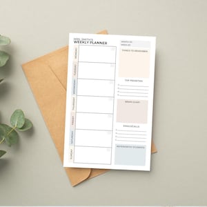 May include: A white weekly planner, featuring the text "MRS. SMITH'S WEEKLY PLANNER", rests on a kraft paper envelope. The planner includes sections for each day, plus areas for notes, priorities, and reminders. It's designed for weekly organisation and planning.