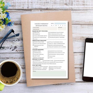 May include: A vision therapist's session notes form on a wooden desk, next to a cup of coffee, a smartphone, and eyeglasses. The form includes sections for client information, observations, and a plan for the next steps.