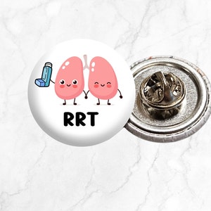May include: White button with a cartoon image of two pink lungs holding hands with an inhaler. The text "RRT" is printed below the lungs.