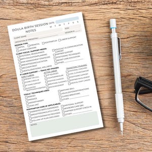 May include: A doula birth session notes sheet with checkboxes, a pen, and glasses on a wooden surface. The sheet includes sections for client information, session type, and tools used. The pen is white with a blue tip.