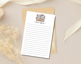 May include: A white notepad with lined pages and a floral design that reads "SCHOOL COUNSELOR" in colorful letters. The name "mrs. rogers" is written below the title in a cursive font. The notepad is on a light brown envelope.