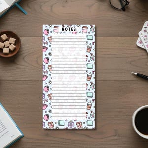 May include: A white ceramic mug with a black handle and the text "But First, Coffee" in a handwritten style. The mug is on a white surface. The mug is approximately 4 inches tall.