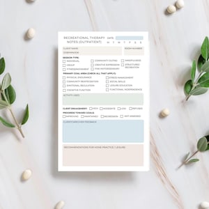 May include: A white and beige recreational therapy notes form with checkboxes and fill-in sections. The form includes sections for client information, session type, primary goals, and client engagement. Green leaves and white decorative objects surround the form.