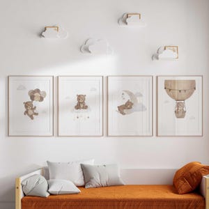 May include: Three framed prints with watercolor illustrations of bears in different settings. The first print shows a bear holding balloons, the second shows a bear sitting on a cloud, and the third shows a bear sleeping on a crescent moon.