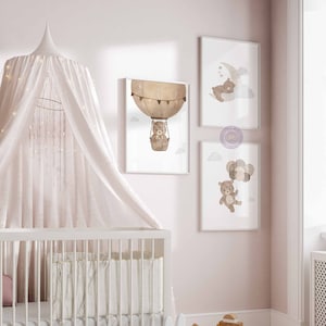 May include: Three framed prints featuring a brown bear in different scenes. The first print shows the bear in a hot air balloon, the second shows the bear sleeping on a crescent moon, and the third shows the bear holding balloons.