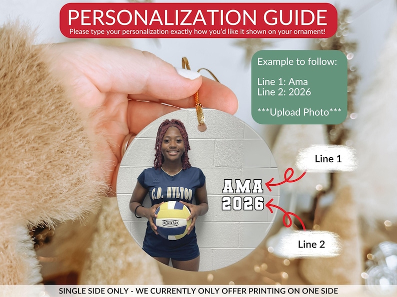 May include: A round white ornament featuring a printed photograph of a person in a navy blue athletic uniform holding a volleyball. The text AMA is printed on line one and 2026 is printed on line two. The ornament includes a gold hanging string.