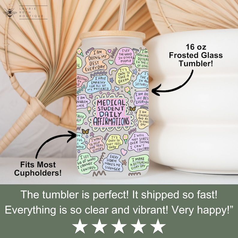 May include: A 16 ounce frosted glass tumbler with a colorful design featuring the text "Medical Student Daily Affirmations". The tumbler has a wooden lid and a straw.