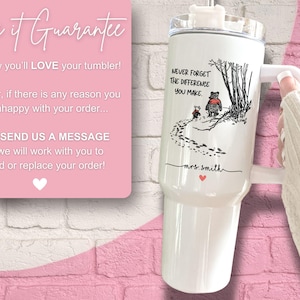 May include: White stainless steel tumbler with a black and white illustration of Winnie the Pooh and Piglet walking in the woods. The tumbler has a lid and a handle. The text "NEVER FORGET THE DIFFERENCE YOU MAKE." is printed on the tumbler. The name "mrs. Smith" is printed below the illustration.