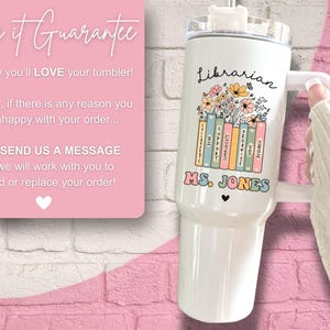 May include: White stainless steel tumbler with a floral design and the words "Librarian" and "MS. JONES". The tumbler has a straw and a handle.