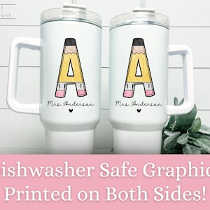 May include: Two white travel mugs with a black pencil design and the text "Mrs. Anderson" on each mug. The mugs are dishwasher safe and have graphics printed on both sides.