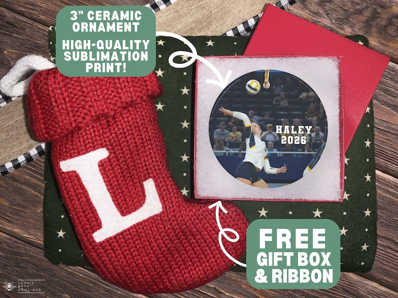 May include: A 3-inch round ceramic ornament featuring a sublimation print of a volleyball player in action, with the text HALEY 2026. The ornament is displayed alongside a red knit stocking with a white letter L and a red gift box.