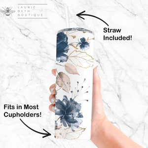 May include: White tumbler with a blue and gold floral design. The tumbler has a lid and a straw. The text "Straw Included!" is written on the right side of the image. The text "Fits in Most Cupholders!" is written on the left side of the image.