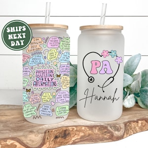 May include: A frosted glass tumbler with a bamboo lid and a straw. The tumbler has a colorful design with the words "Physician Assistant Daily Affirmations" and a stethoscope with a heart that says "PA" and the name "Hannah".