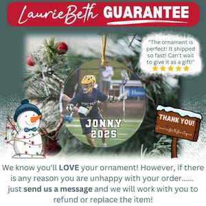 May include: A clear, round ornament featuring a lacrosse player in a navy blue uniform with the name "JONNY" and the year "2025". The ornament has a gold string for hanging and is surrounded by festive holiday decorations.