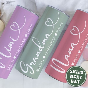 May include: Three stainless steel tumblers with personalized names and a heart design. The tumblers are in shades of pink, green, and red.