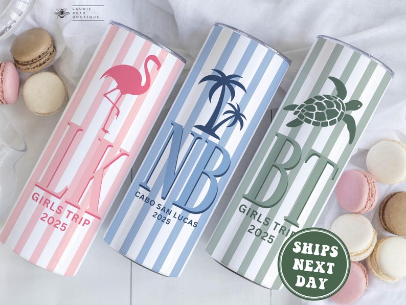 May include: Three personalized travel tumblers with vertical stripes. One is pink with a flamingo, another is blue with palm trees, and the last is green with a turtle. Each has initials, "GIRLS TRIP 2025" and "CABO SAN LUCAS 2025".