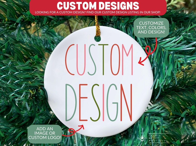May include: A white ceramic ornament with the words "CUSTOM DESIGN" in red, pink, and green lettering. The ornament has a gold string for hanging and is surrounded by green Christmas tree branches. Text on the ornament says "Customize text, colors, and design!"